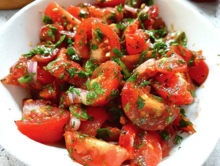 Fresh Lebanese tomato salad with cucumbers, parsley, and mint, showcasing Mediterranean flavors.