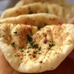 Homemade no-oven Turkish bazlama flatbread served with dips, showcasing its soft texture and rustic presentation.